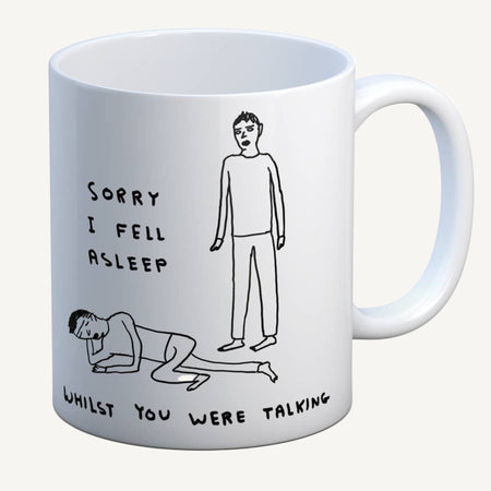 White mug with black illustrations and text on a white background. The text says, sorry I fell asleep whilst you were talking.