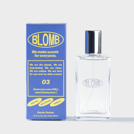 Blomb branded perfume bottle and yellow and violet branded packaging on a white background