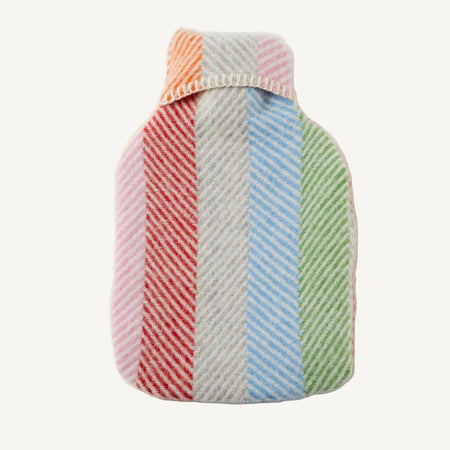 Pure new wool colourful rainbow striped hot water bottle cover with hot water bottle inside on a white background