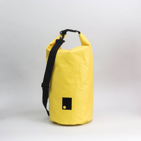 Yellow waterproof bag with a black strap on a light gray background