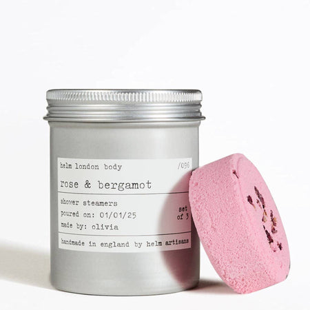 Aluminium screw top tin labeled 'Rose & Bergamot' with a pink shower steamer on a white background