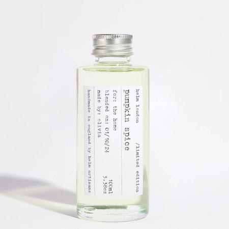 Pumpkin spice diffuser oil in a glass bottle on a white background
