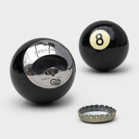 The Eight Ball Bottle Opener is part gadget, part icon, and 100% conversation starter. Crafted from a genuine black number eight pool ball. Bottle opener shaped like a pool ball with a silver cap on a white background