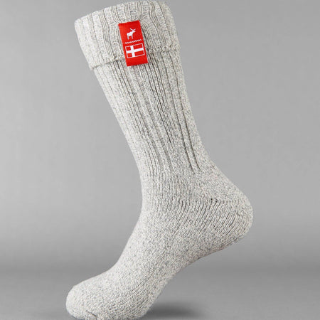 Sky grey knitted Danish Hygge socks with a Danish flag brand label on a gray background. Lambswool and cotton rich to get you through the cold Arctic nights.