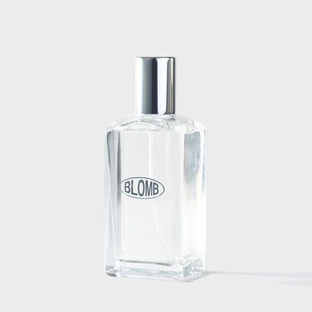 Clear Blomb branded perfume bottle with silver cap on a white background
