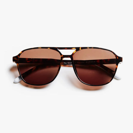 Tortoiseshell sunglasses with brown lenses on a white background