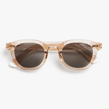 Sunglasses with a pink transparent frame and dark lenses on a white background