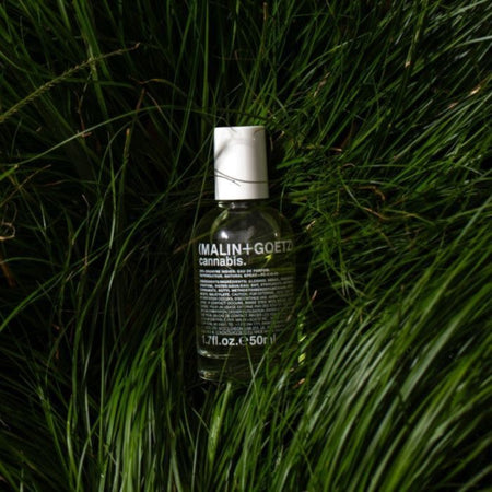 Malin+Goetz eau de parfum bottle on grass