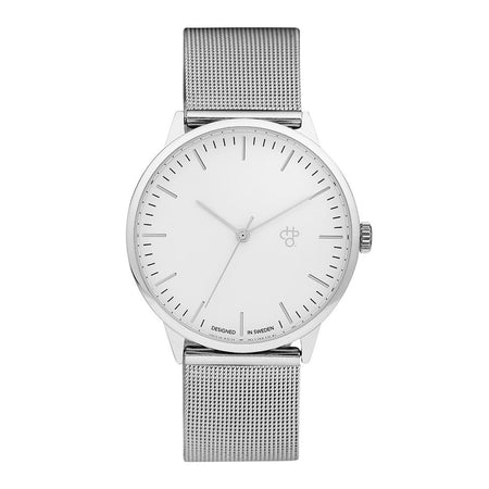 Silver watch, white face with a stainless steel mesh band on a white background
