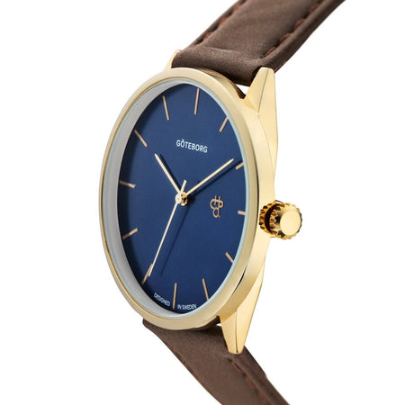 Watch with blue dial, gold case, and brown leather strap on a white background