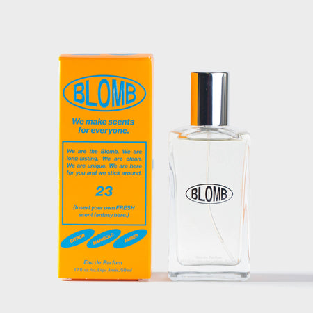Blomb branded perfume bottle and orange and blue branded packaging on a white background