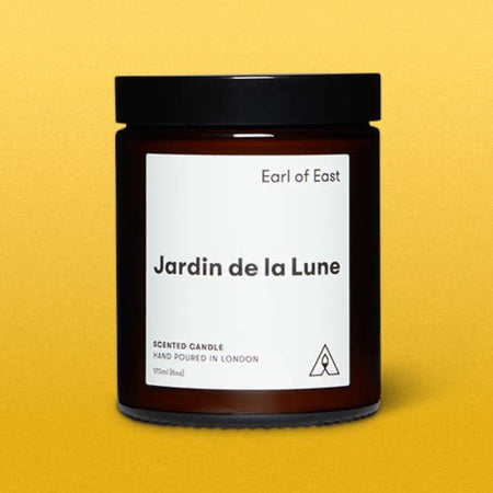 Candle jar labeled 'Jardin de la Lune' by 'Earl of East' on a yellow background