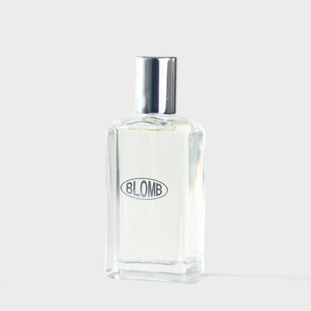 Clear glass bottle with silver cap on a white background, featuring the brand 'BLOMB'.