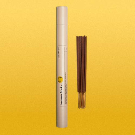 Incense sticks contained in a long cylinder tube with Earl of East branding on a yellow background