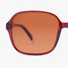 Sunglasses with red frame and brown lens on a white background