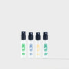 Four transparent spray bottles with black nozzles, Blomb logo and visible numbers on a white background