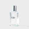 Clear Blomb branded perfume bottle with silver cap on a light gray background