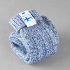 Baltic blue knitted Sisu of Finland socks with a Finnish flag brand label on a gray background. Lambswool and cotton rich to get you through the cold Arctic nights.