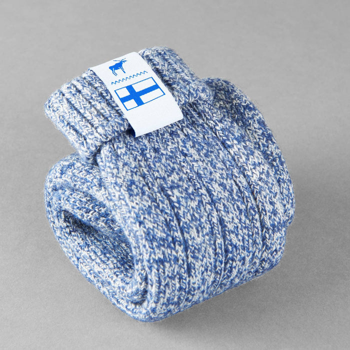 Baltic blue knitted Sisu of Finland socks with a Finnish flag brand label on a gray background. Lambswool and cotton rich to get you through the cold Arctic nights.