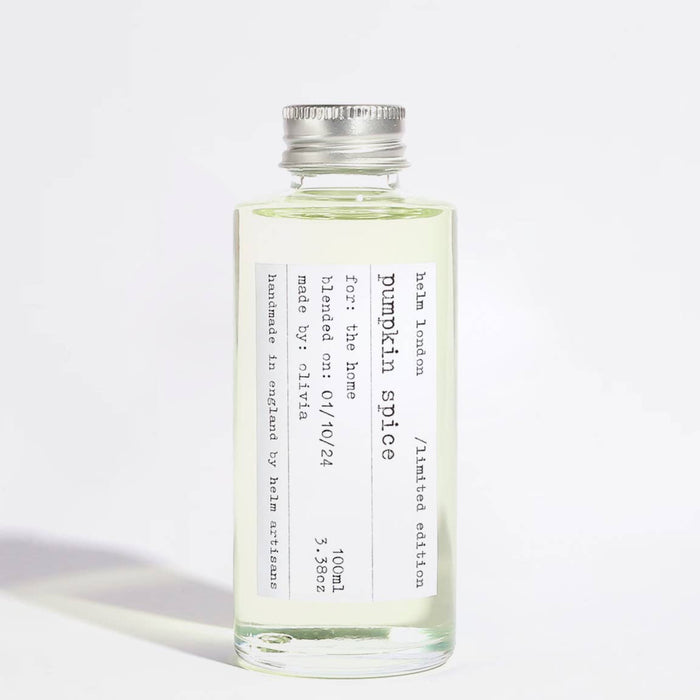 Pumpkin spice diffuser oil in a glass bottle on a white background