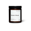 Amber glass candle jar with screw top labeled 'Smoke & Musk' by 'Earl of East', hand poured in London