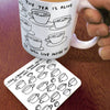 White mug with tea cup illustrations and text, held by a hand on a wooden surface with matching coaster.