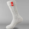 Sky grey knitted Danish Hygge socks with a Danish flag brand label on a gray background. Lambswool and cotton rich to get you through the cold Arctic nights.