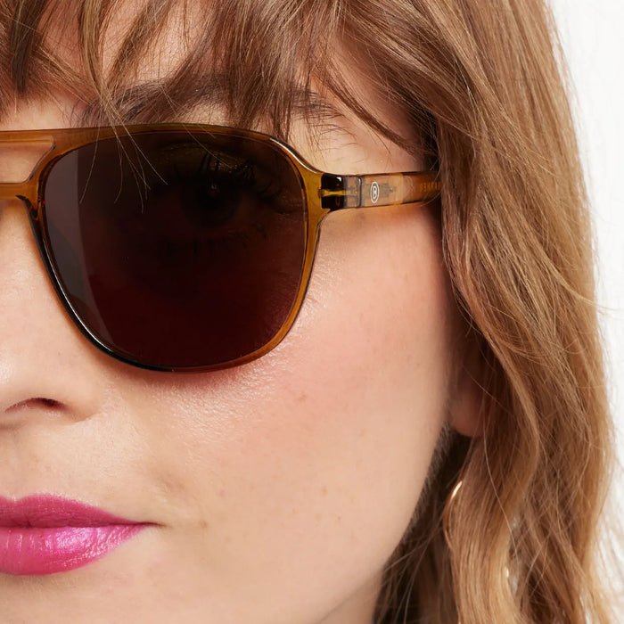 Close-up of a person wearing sunglasses with a blurred background