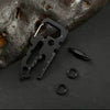 Black multi-tool with components on a dark surface with a rock background