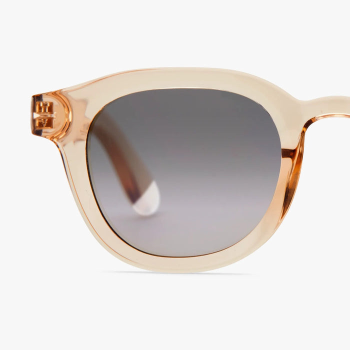 Pink-framed sunglasses with a gradient gray lens on a white background