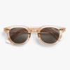 Sunglasses with a pink transparent frame and dark lenses on a white background