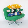 Green chair with colourful cushions on a white background