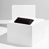 Black glasses case in a white box on a light gray background