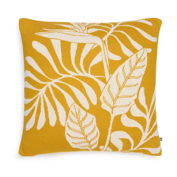 Yellow cushion with ivory leaf pattern on a white background