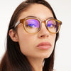 Close-up of a person wearing glasses with a white background