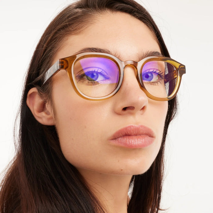 Close-up of a person wearing glasses with a white background