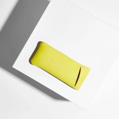 Yellow glasses case with brand logo on a white and gray background