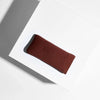 Brown glasses case with 'Barner' branding on a white surface