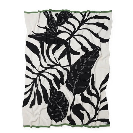 Throw with black leaf pattern on an ivory background