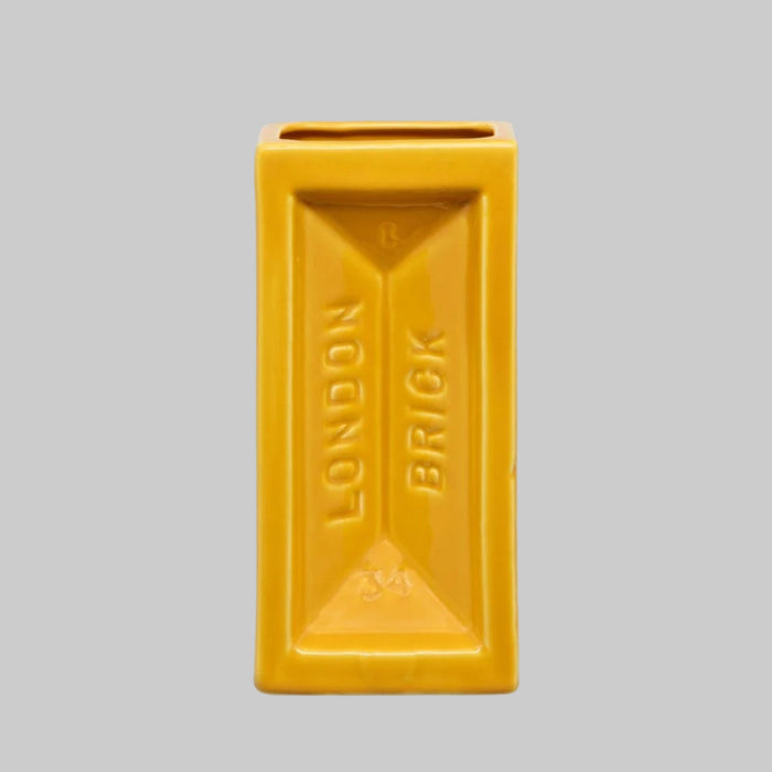 Yellow rectangular vase with 'London Brick' text on a gray background