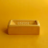 Rectangular ceramic soap dish with 'London Brick' engraving on a yellow background