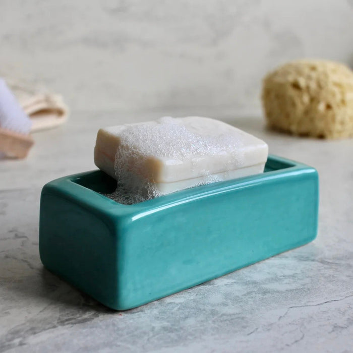 Turquoise London Brick soap dish with a bar of soap on a marble surface