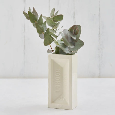 White London Brick vase with eucalyptus leaves on a light wooden background