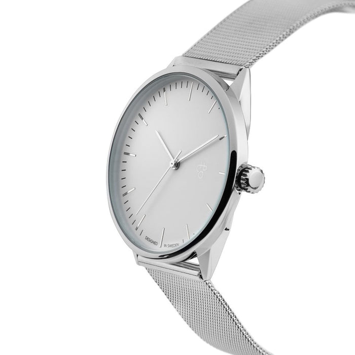Silver watch with a mesh band on a white background
