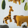 Felt animal mobile with giraffe, lion, and zebra on a white background