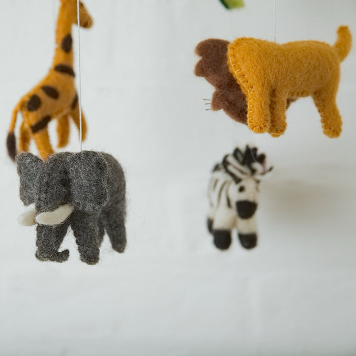Felt animal toys including a elephant, zebra, giraffe, and lion on a white background