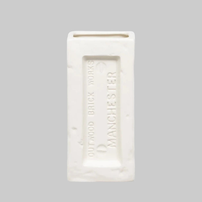 Rectangular white vase with 'Outwood Brick Works Manchester' text on a light gray background.