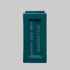 Teal brick vase with 'Outwood Brick Works Manchester' branding on a gray background. Perfect for design lovers who appreciate function with an industrial edge.