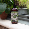 Bottle of lemongrass and lime hand wash with a Kew Gardens archival illustration label on a windowsill with plants.