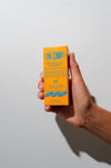 Hand holding a box of number 23 Blomb branded perfume against a white background